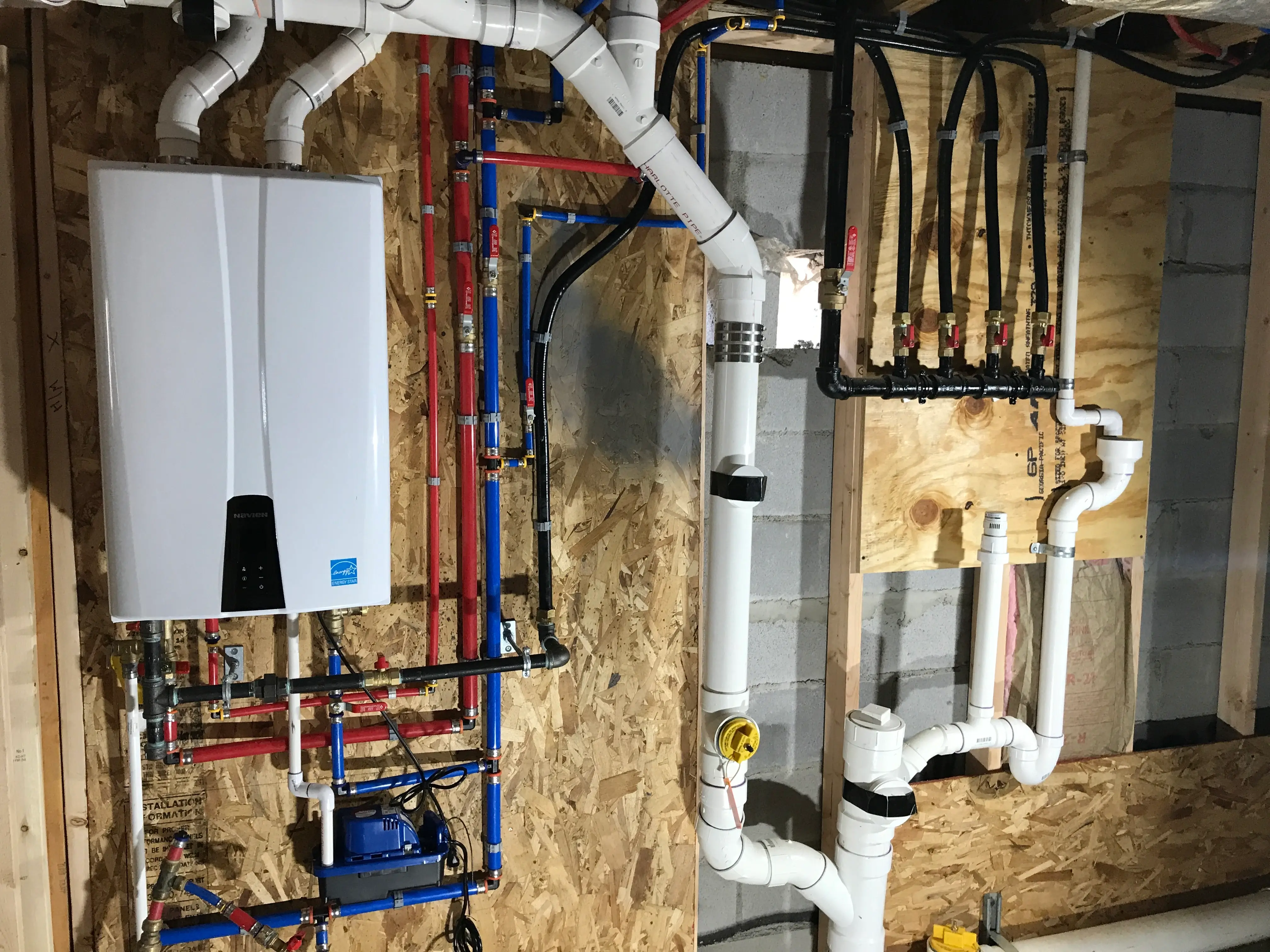 Complete tankless water heater system with PEX manifold and circulation pump